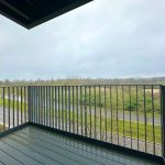 Balcony view of overcast landscape and road.