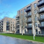 Modern apartment buildings with balconies and trees