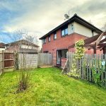 Residential garden with shed and climbing plants.
