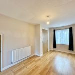 Empty room with wooden floor and window.