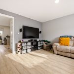 Modern living room with sofa and wall-mounted TV.