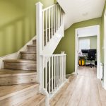 Modern staircase with home office in background