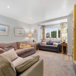 Cosy living room with sofas and large window.