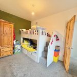 Children's room with bunk bed and wardrobe.