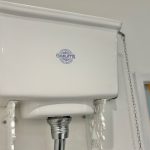 White toilet cistern with pull chain