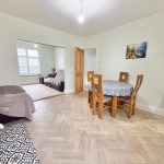 Dining area with wooden chairs and table.