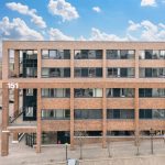 Modern brick office building with large windows.