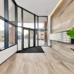 Modern lobby with mailboxes and large windows.