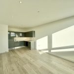 Modern kitchen with light wooden flooring