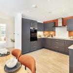 Modern kitchen with dining area and appliances.