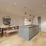Modern kitchen with island and dining area.