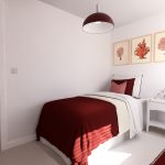 Cosy bedroom with red decor and wooden door.