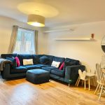 Cosy living room with blue corner sofa.