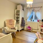 Cosy children's room with toys and play kitchen.