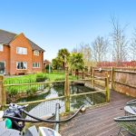 Brick house with garden and pond.