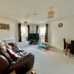 Modern living room with brown sofa and TV.