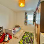 Children's bedroom with toys and colourful decor.