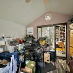 Home studio with drum kit and bookshelves.