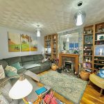 Cosy living room with corner sofa and fireplace.