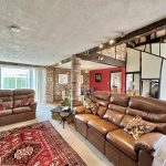 Cosy lounge with leather sofas and spiral staircase.
