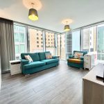 Modern living room with large windows and sofas.