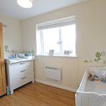 Bright nursery with cot and changing table.
