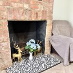 Brick fireplace with flowers and gold deer ornaments.