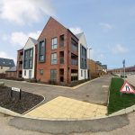 Modern residential buildings on quiet street corner.