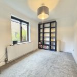 Empty room with bookshelf and window view.