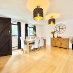 Spacious dining room with wooden furniture and decor.