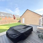 Modern garden with decking and covered furniture