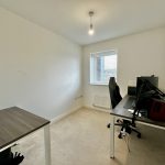 Minimal home office with desk and computer setup.