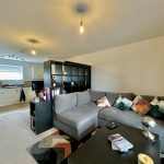 Modern open-plan living room and kitchen interior.