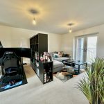 Modern living room with a racing simulator setup.