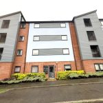Modern apartment building with brick and grey cladding.