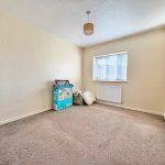 Empty room with carpet and window.