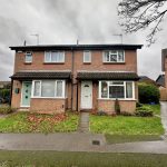 Semi-detached brick house on overcast day.
