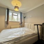 Modern bedroom with bed and treadmill
