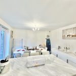 Modern dining room with festive table settings.