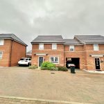 Brick houses with driveway and parked car