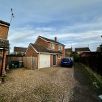 Detached house with driveway and parked car