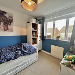 Child's bedroom with blue accents and Star Wars decor.