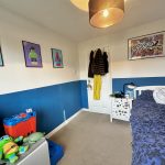 Bedroom with LEGO posters and toys.