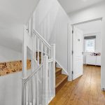 Modern staircase and hallway in white interior