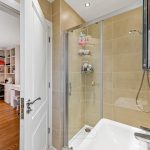 Modern bathroom with open door to home office