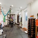 Home gym with equipment and boxing bag.