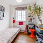 Bright craft room with sewing machine and plant.