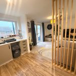 Modern interior design of combined kitchen and living room.