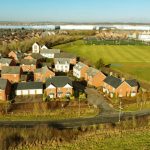 Aerial view of suburban houses and sports fields.