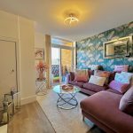 Stylish living room with colourful decor and natural light.